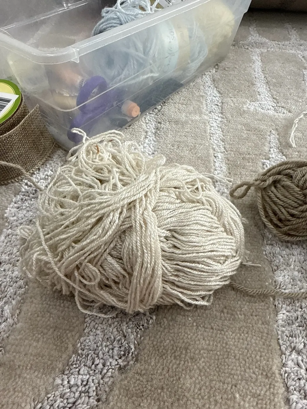 Skeins of wool yarn matched by color to rebuild a rug's fringe and pile