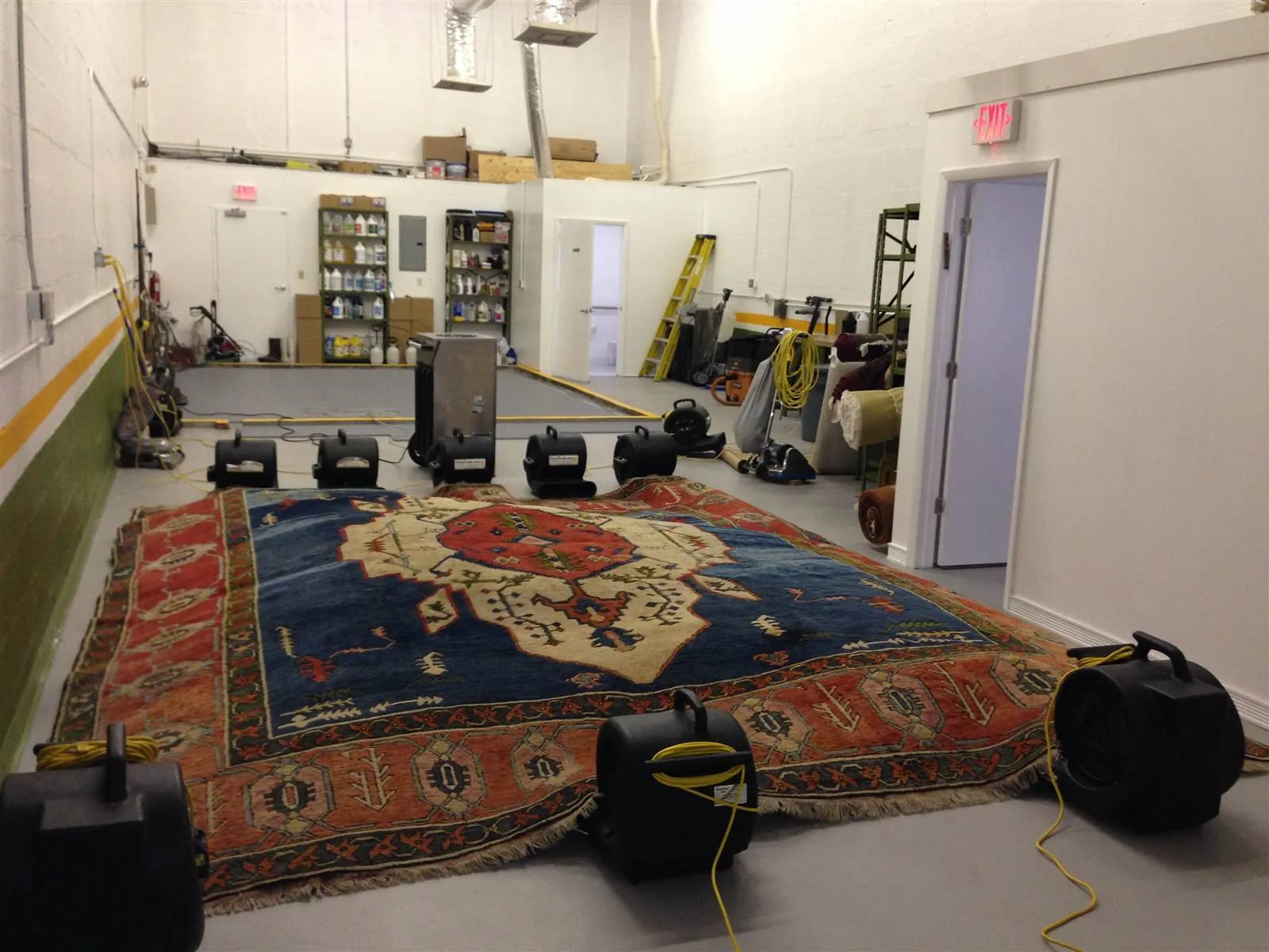 Rugs hung to dry in the plant's temperature and humidity controlled room
